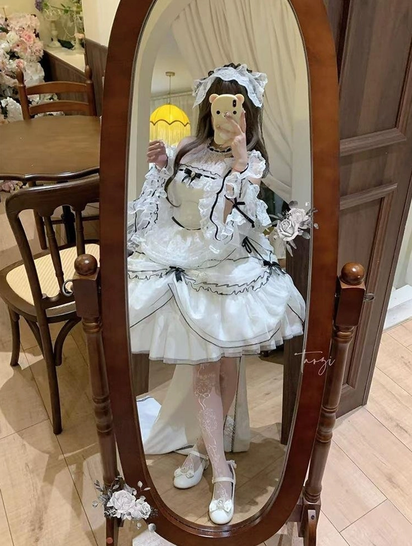 Sweet lolita wedding dress paired with coordinating accessories including black lace parasol, hair bonnet and head veil for complete formal ensemble