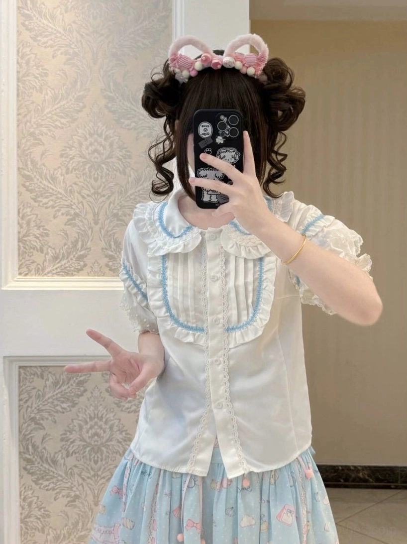 sweet lolita blouse white with blue striped ruffled lace trim collar placket worn with blue printed skirt pink cat ear hairpin selfie close-up indoor