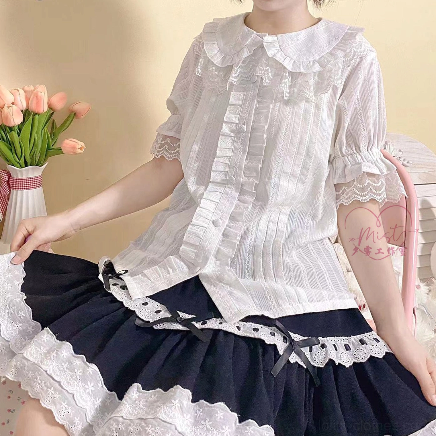 White lolita peter pan collar short sleeve blouse puff sleeves lace cuffs front pleated model wearing half-body view