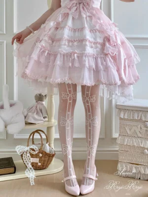 Sweet lolita thigh-high sheer socks with white bow and polka dot vertical stripe pattern worn with pink frilly sweet lolita dress and pink mary jane flats in vintage French interior setting showing full front leg view and delicate lace cuff trim