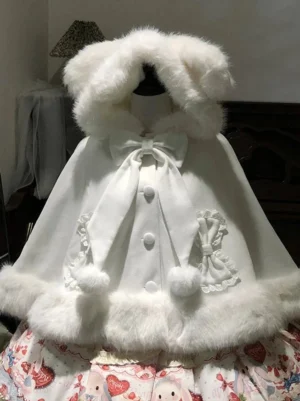 Pure white Sweet Lolita bunny ear hooded cape with white fluffy trim and front bow details on mannequin paired with strawberry print skirt