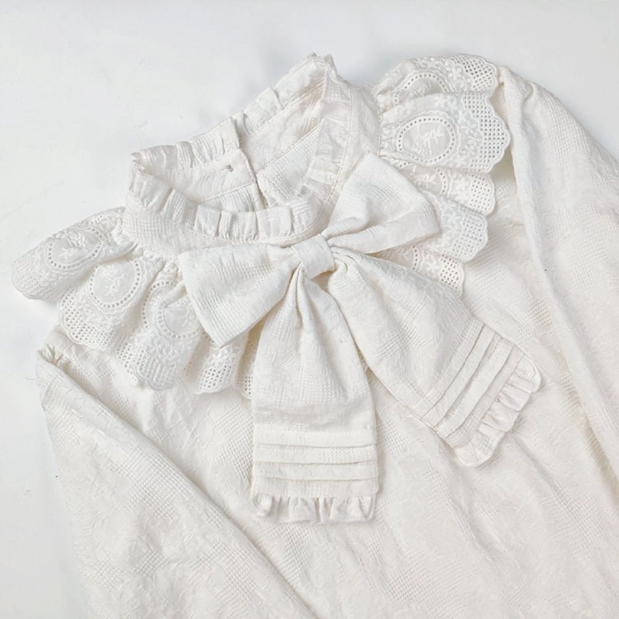 Pure white sweet lolita cotton blouse close-up detail shot showing intricate embroidered lace ruffled collar and structured fabric bow with pleated trim