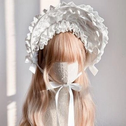 Sweet lolita white lace bonnet front view with light brown curly wig, white ruffled lace brim, delicate satin chin straps small bows
