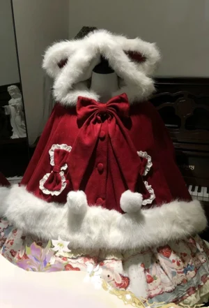 Sweet Lolita wine red bunny ear hooded cape with white fluffy trim and detachable bow displayed on mannequin with strawberry printed skirt front view