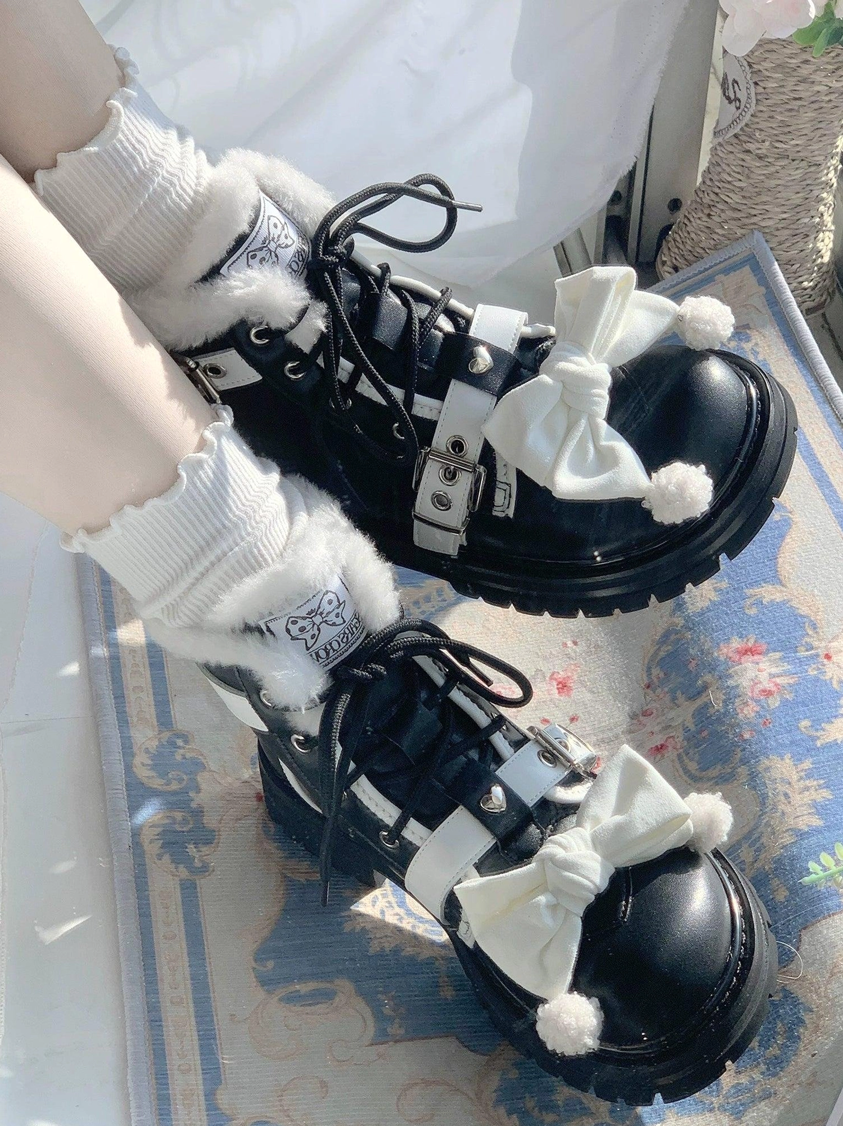 Sweet lolita winter boots overhead side view pair shoes black leather finish white bow pom-pom details silver buckle straps lace-up