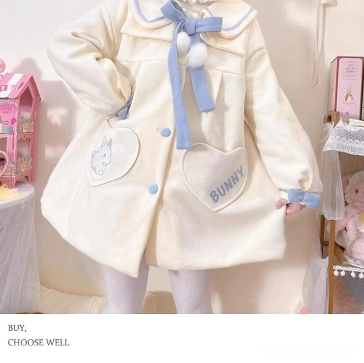 Sweet lolita wool winter coat front half-body pose showing hand on hip displaying left bunny embroidery pocket blue bow tie front button arrangement and doll-like aesthetic