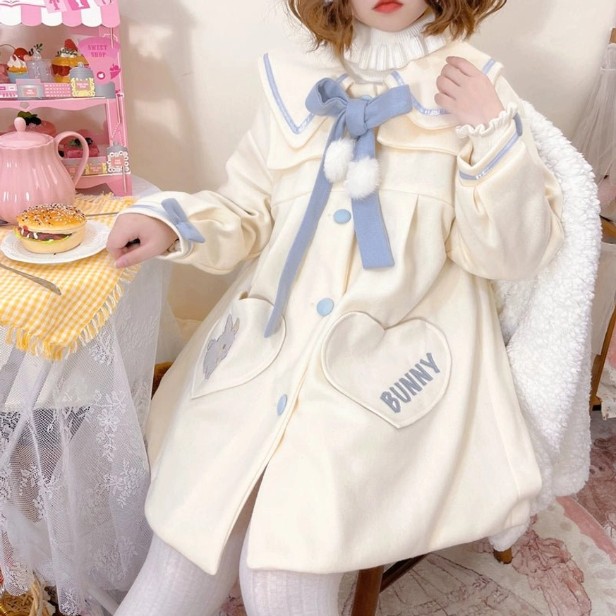 Sweet lolita wool winter coat front full-body view hand resting on fluffy chair blue collar bow heart bunny pockets embroidery sleeve trims cream color afternoon tea setting