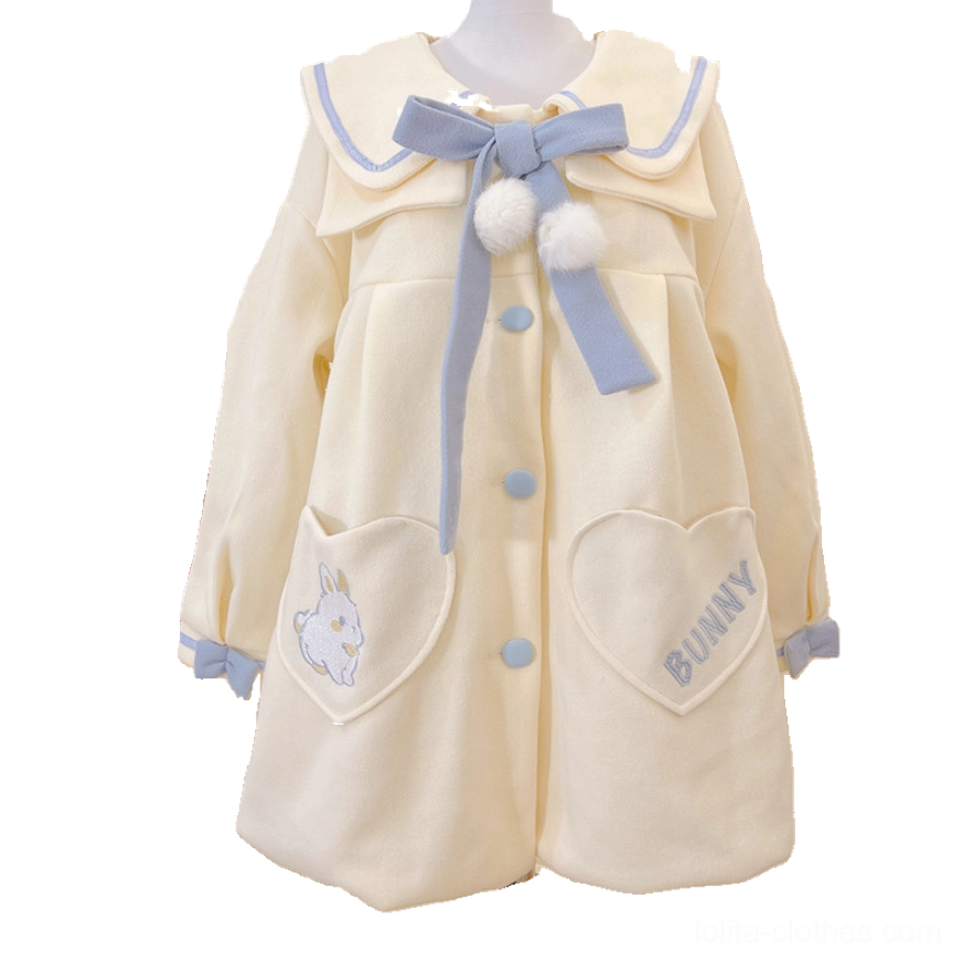 Sweet lolita wool winter overcoat close-up texture photography showcasing premium woolen fabric quality blue cuff trim details heart pocket embroidery and doll aesthetic elements