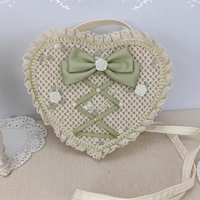 Sweet Lolita woven heart crossbody bag with green bow pearl flower ornaments ruffled lace trim and gold edging front view