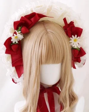 Sweet strawberry lolita bonnet frontal flat view with ivory ruffled lace trim, burgundy satin bows, artificial strawberries and daisies on mannequin with light golden bangs