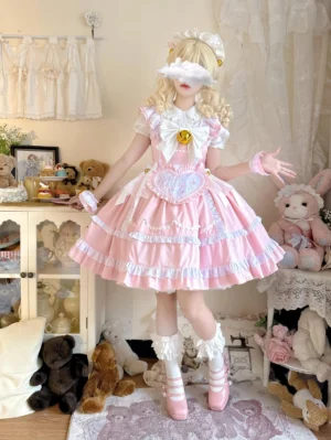 Pure pink Sweetheart Chef sweet lolita JSK dress with white chest bow featuring golden bells, layered ruffled skirt and detachable heart apron, full-body front view in doll room setting