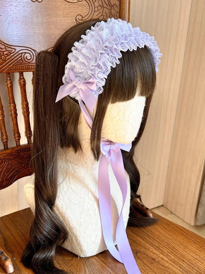 Taro purple lace KC headdress displayed on mannequin, showcasing rich jewel-tone purple ruffled lace with coordinating satin bow and flowing ribbon