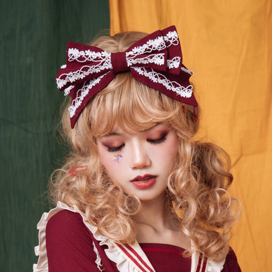 Teal blue sweet lolita KC headband with white lace trim on model in maid dress