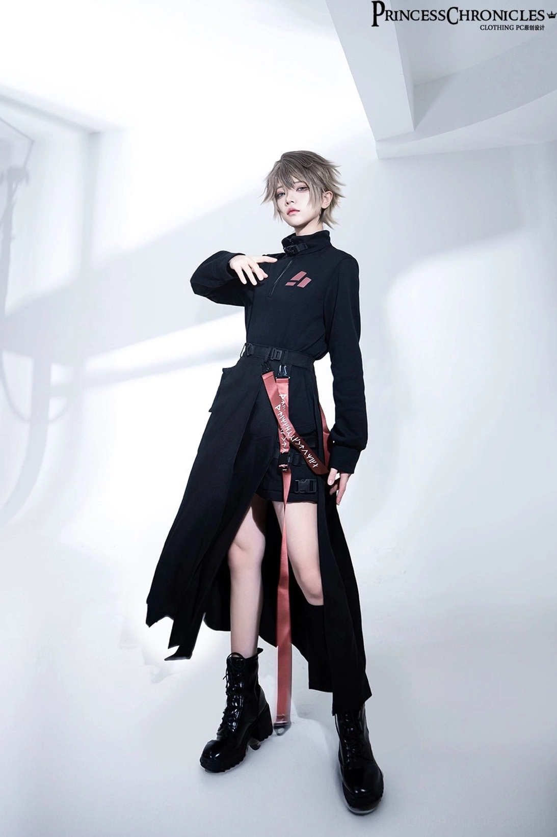 Three-quarter techwear styling view with right hand on shoulder highlighting high side skirt split design