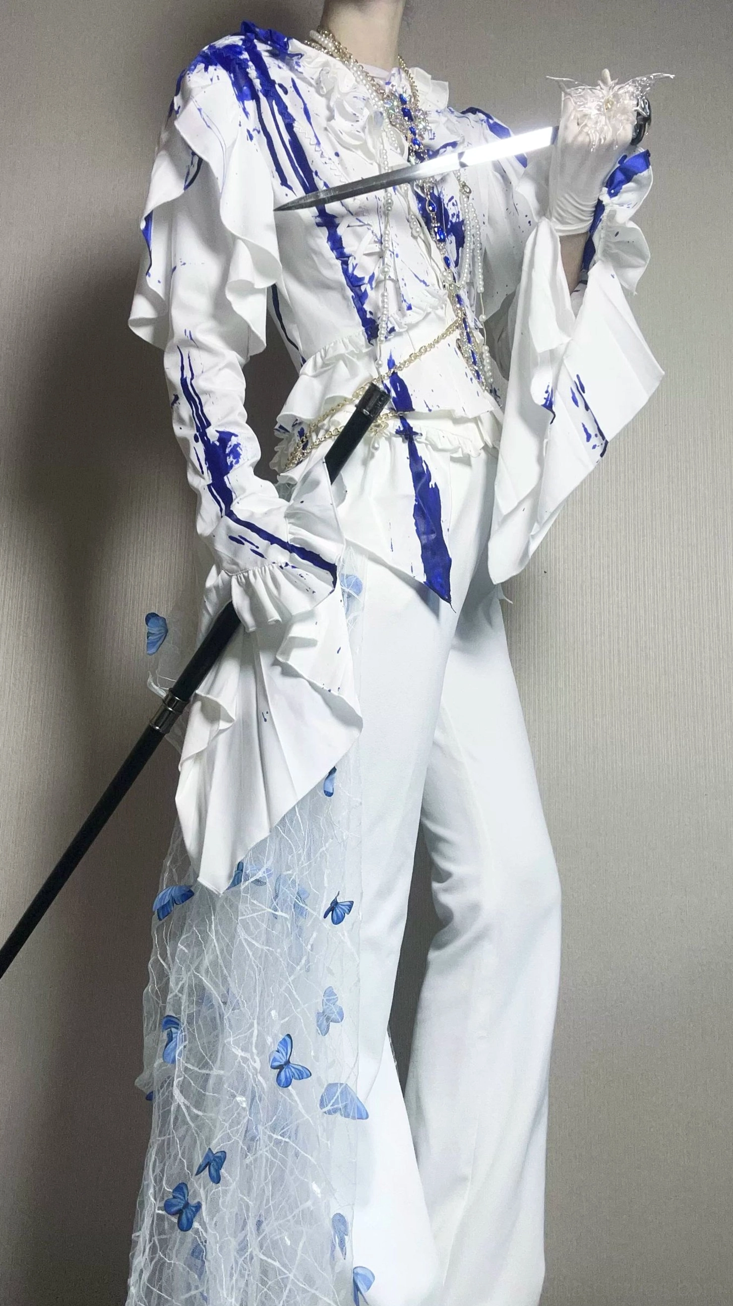 Theatrical presentation of Ouji lolita trailing blouse featuring dramatic posing with props, showcasing garment's visual impact for alternative fashion photography and content creation