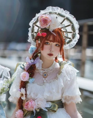 Red-haired model wearing vintage pearl wedding Lolita necklace with white ruffled dress flower bonnet and fresh flower hair accessories styled coordination