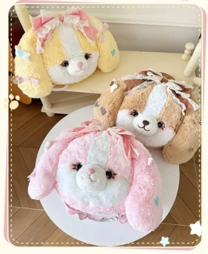 Three color variants of kawaii puppy plush lolita backpacks displayed together, yellow brown and pink with delicate lace bow details