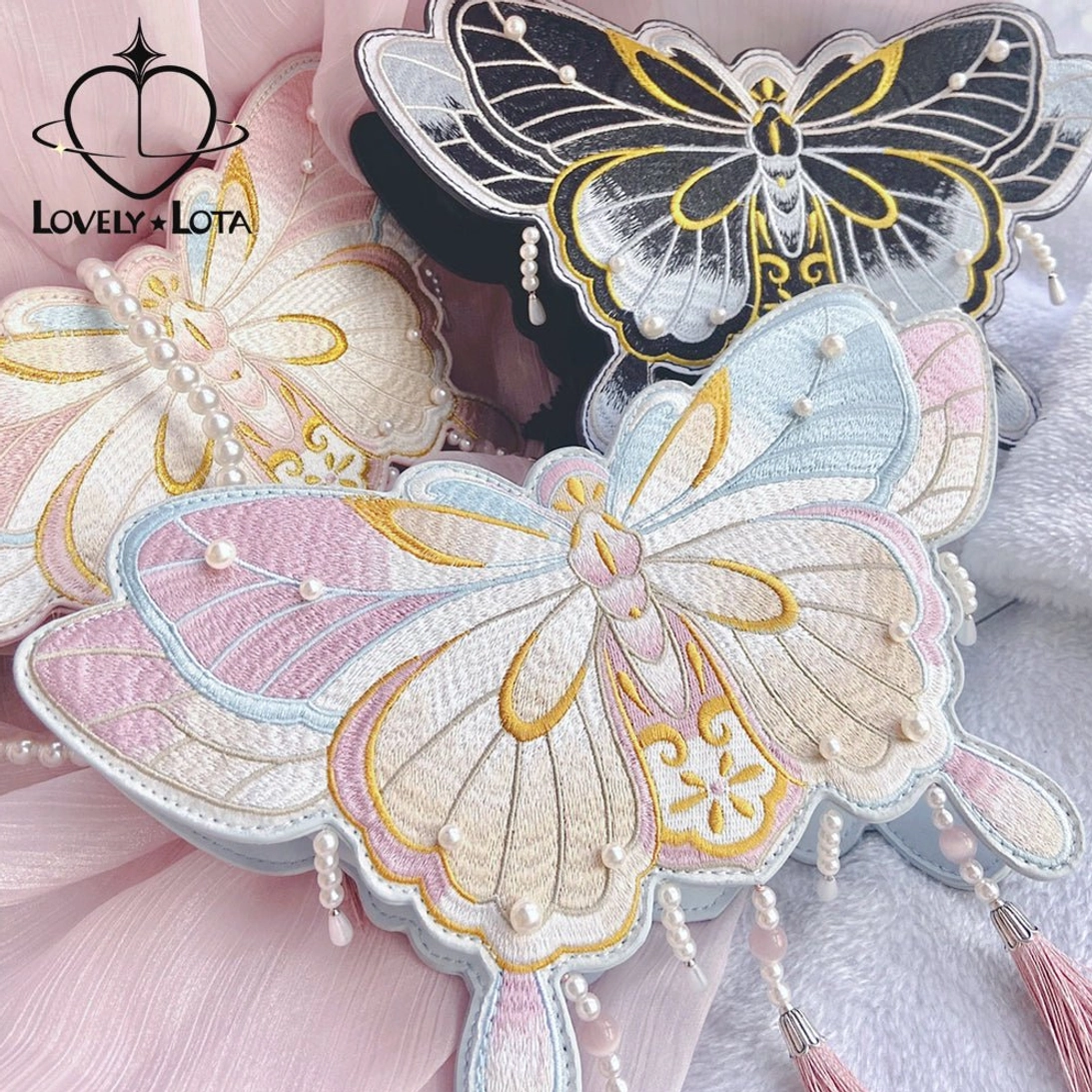 Three Chinese Qi Lolita butterfly bags in different colors beige-pink light blue-pink and black-gold with tassels and pearls overhead view
