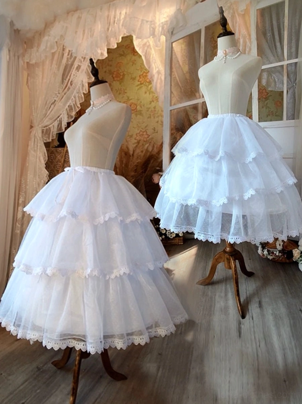Tiered white lolita petticoat front side display on dress mannequins with lace hem trim and wooden floor