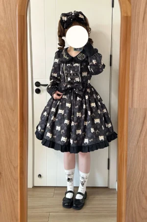 Full body black tiger print kawaii lolita one-piece dress with long puff sleeves white crew socks black Mary Jane shoes and matching waist bow shown in indoor mirror reflection