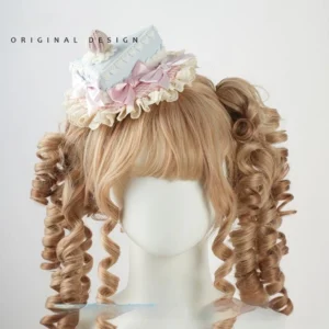 Triangular cake decoration sweet lolita top hat fascinator with light blue cake slice base, pink gingham underlayer, cherry cream topper, ruffled lace trim, frontal view