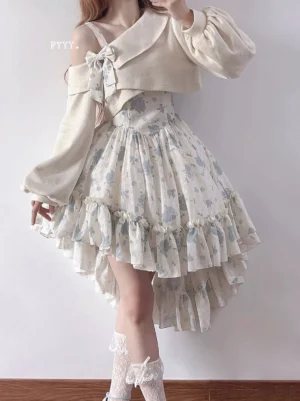 Close-up detail view of Twilight Rose lolita ensemble showing blue floral print high-waist ruffled jumper skirt with cream off-shoulder sweater, paired with white lace ankle socks and elegant footwear styling