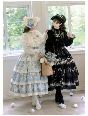 Twin four-tiered classic lolita JSK suits in blue daisy and black lily colorways with ruffled shoulders and embroidered details displayed on two models in indoor setting