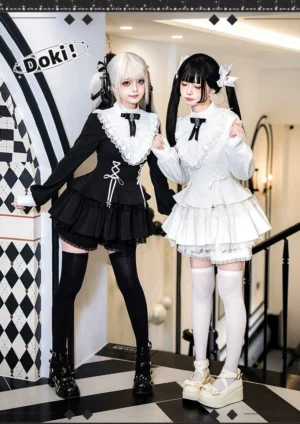 Twin gothic lolita OP dresses in black and white with ruffled doll collar and chest bow tie, featuring tiered ruffle skirt design, front full-body view on twin ponytail models