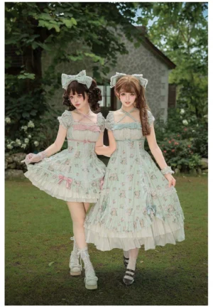 Twin classic lolita OP dresses with mint green rose print and tiered ruffled skirts worn by two models in vintage garden setting