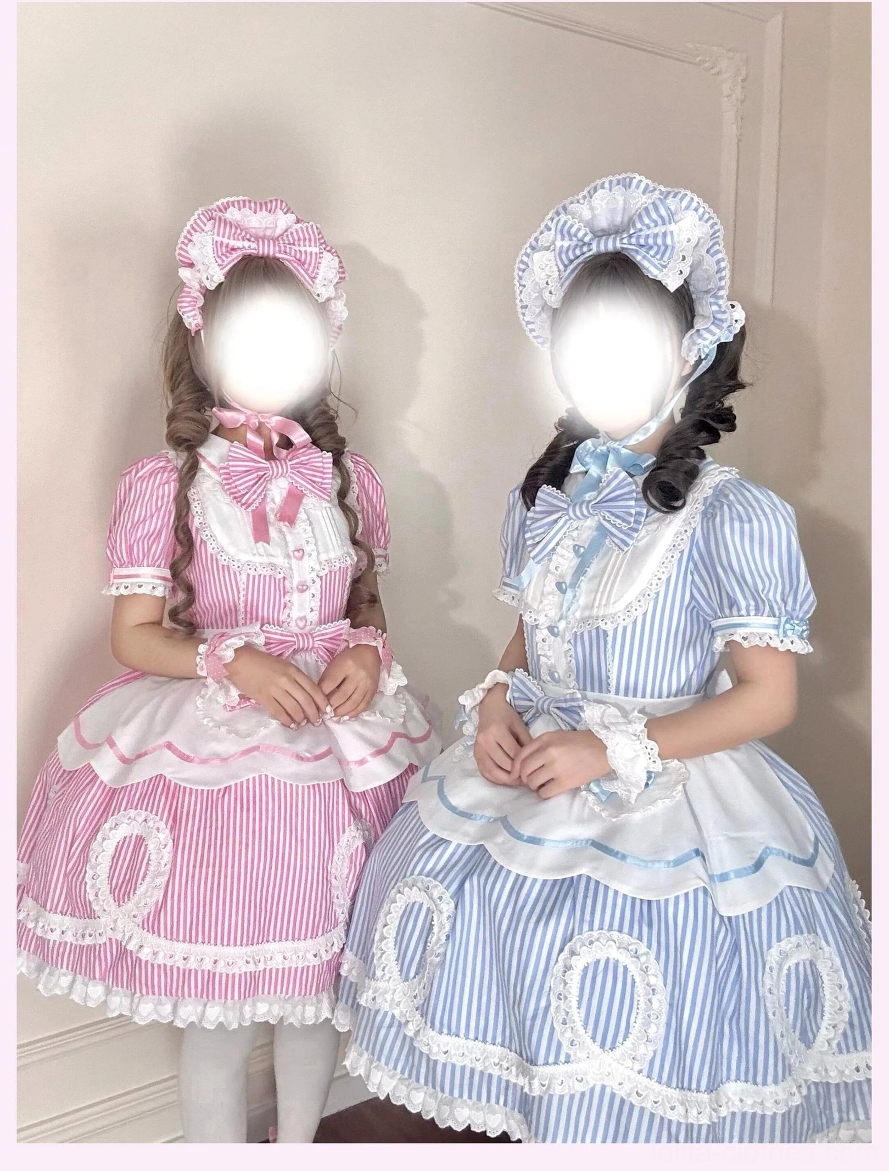 Two models in coordinated pink and blue striped lolita OP dresses showing matching set aesthetic and twin styling