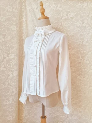 Lolita blouse side three-quarter view showing slim fit long sleeves with ruffled cuffs and stand collar