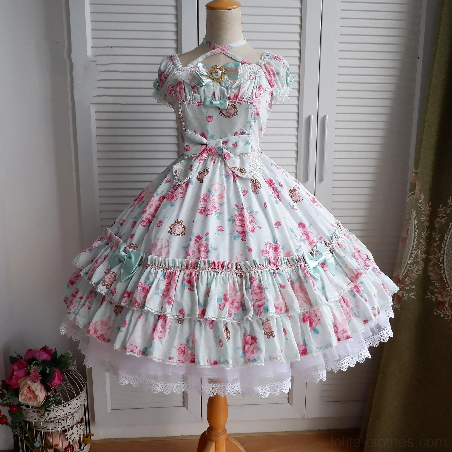 Front full view of floral vintage Lolita dress with petticoat showing off-shoulder neckline, waist bow decoration, and pastel vintage floral fabric