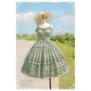 Vintage sage green lolita JSK jumper skirt featuring tiered ruffled skirt with lace edging sweetheart neckline and spaghetti straps, mannequin display outdoors in rustic countryside backdrop with straw hat