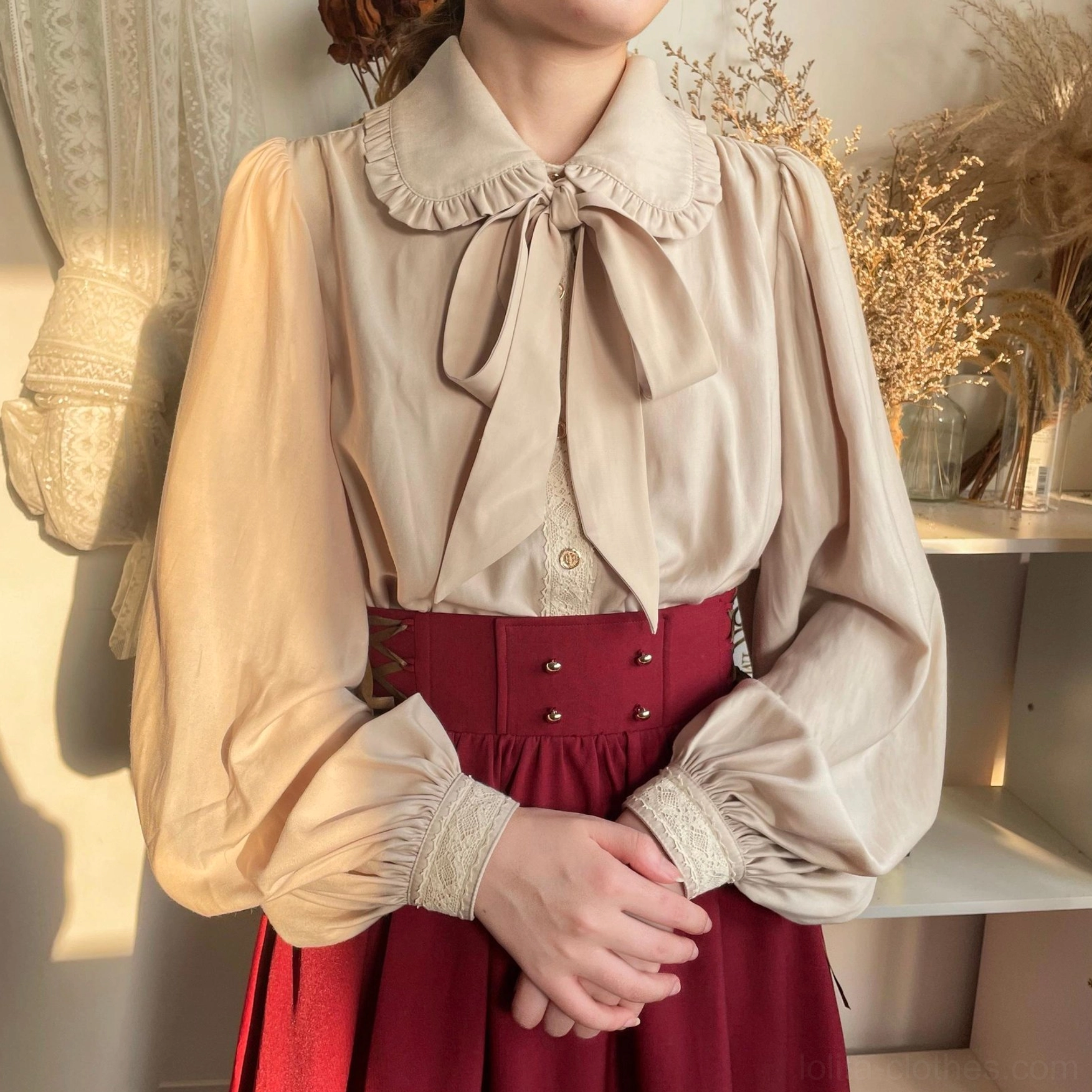 Beige vintage lolita bishop sleeve blouse close-up ruffled Peter Pan collar large satin bow lace-trimmed cuffs