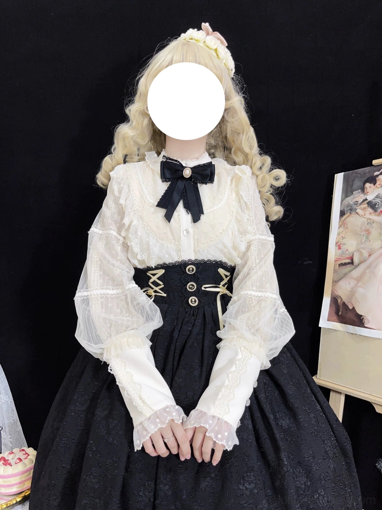 Cream Lolita blouse featuring ruffled stand collar, front button placket, sheer lantern sleeves with lace-trimmed cuffs paired with black high-waisted skirt featuring corset-style waistband, straight front view