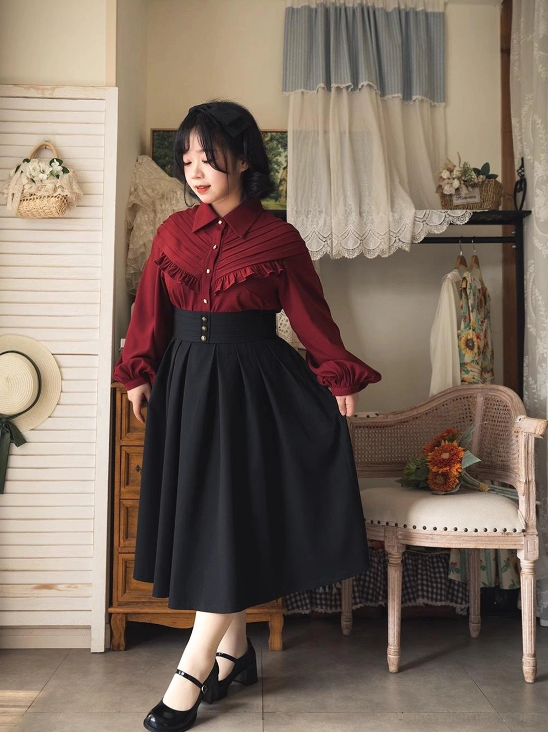 Burgundy vintage Lolita bow blouse detail shot showing intricate ruffled yoke, statement satin bow tie, long bishop puff sleeves, and front button closure with elegant fabric texture