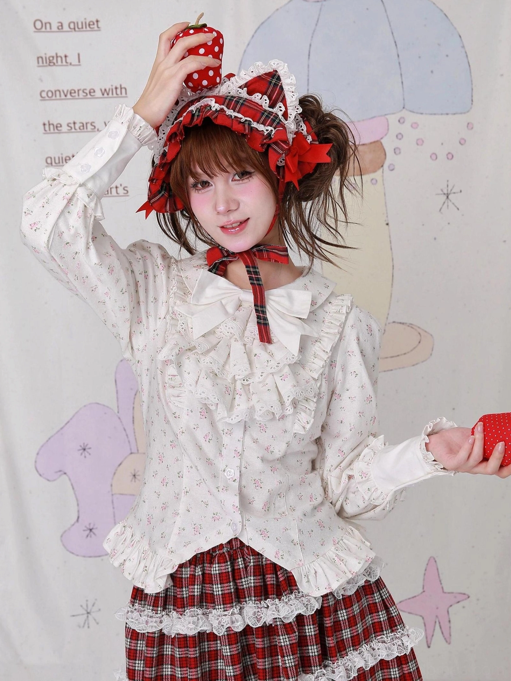 Lolita fashion outfit styling with floral cotton blouse and layered plaid maxi skirt - model posing with strawberry prop, wearing red gingham bonnet and coordinating neck tie