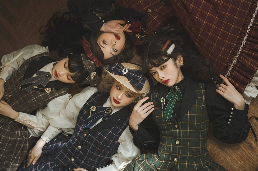 Group of vintage lolita formal wear with plaid color schemes tailored waistcoats ruffled dress hems