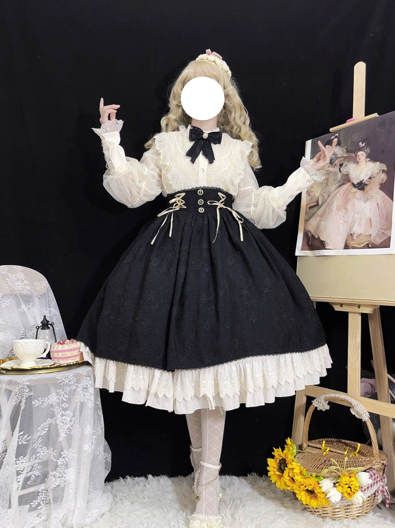 Full-length Lolita coordinate set displayed on faceless blonde model wearing cream blouse with lantern sleeves and embroidered lace panel paired with black high-waisted skirt, vintage studio setting with oil painting easel and dessert table