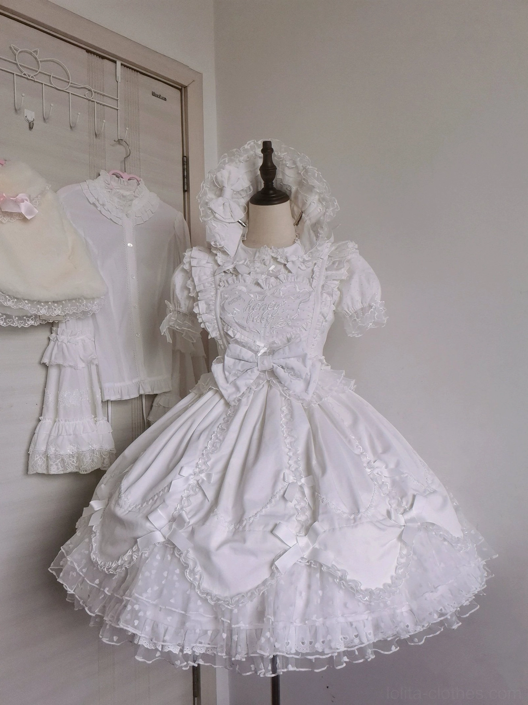 Vintage Lolita dress petal hem detail close-up showing satin ribbon and embroidered decoration