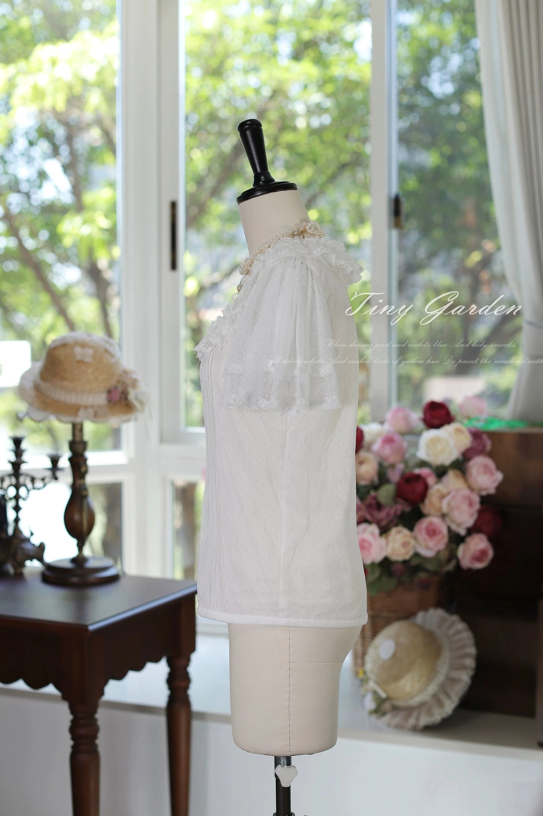 Side full-body view of vintage lolita square neck tulle blouse featuring cream sheer tulle fabric, ruffled shoulder sleeves, minimalist elegant square neckline design and romantic silhouette with vintage hat props