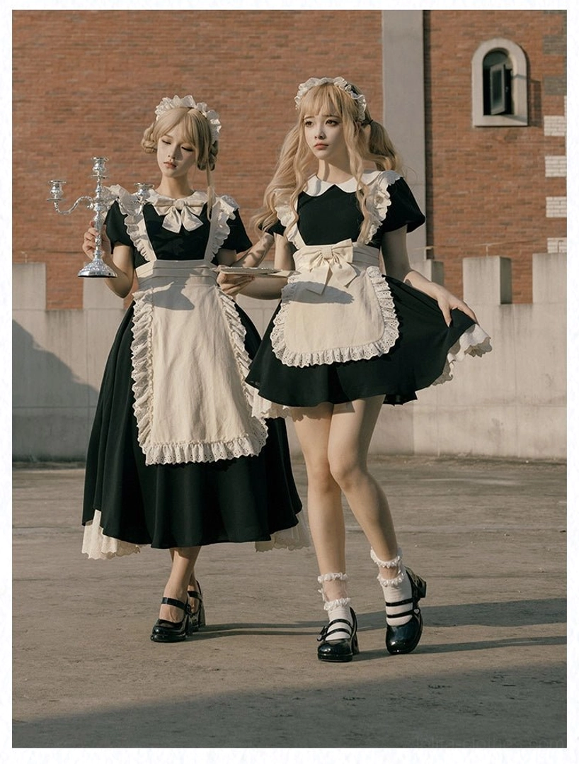 Vintage maid lolita OP dress with fixed apron worn by blonde models in twin coordinate at outdoor brick building setting