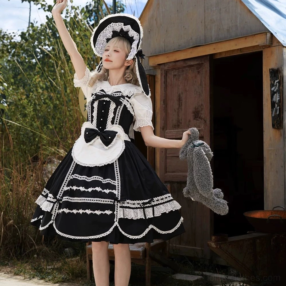 Black-white maid Lolita one-piece dress with bunny-ear bonnet, scalloped lace trims, and detachable accessories outdoor photoshoot