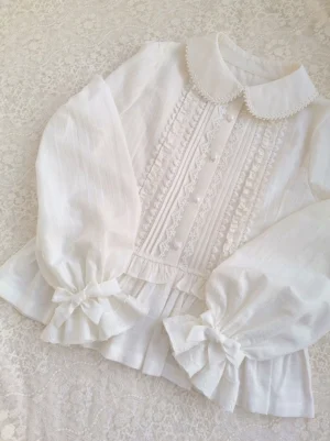 Off-white kawaii lolita long sleeve blouse with peter pan lace collar flat lay vintage background top view