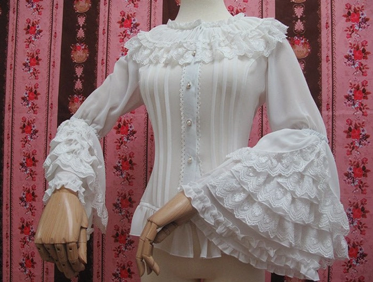 White retro lolita blouse three-quarter front view showing asymmetrical mannequin hand pose layered lace sleeves vertical body pleats