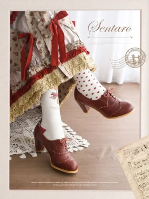 Vintage red-brown lolita leather block heel shoes with hand-carved brogue details and lace-up front fastening, styled with vintage floral print skirt and polka dot socks in studio setting