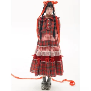 Full-body front view of vintage red tartan Lolita OP dress on model with twin braids and long red hair ribbon, featuring ruffled Peter Pan collar and tiered gingham plaid skirt with white lace trims