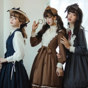 Three elegant models wearing coordinated vintage striped lolita dresses with fishbone design, ruffled hems, and lace trim in group front three-quarter view showcase