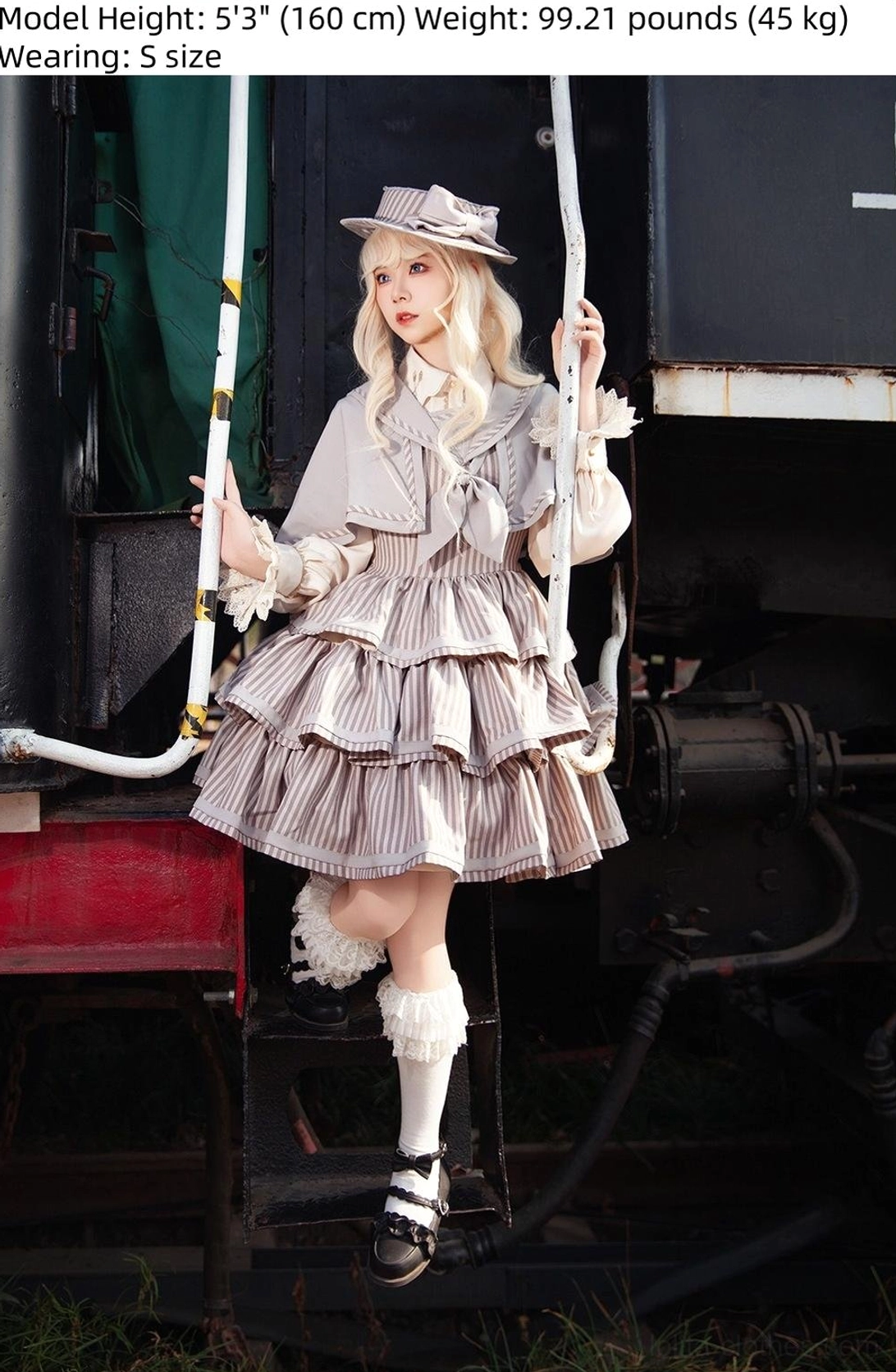 Back view of vintage striped peppy sailor Lolita JSK on dress form, displaying back waist ties for silhouette enhancement, rear fastening detail, and structured suiting fabric construction