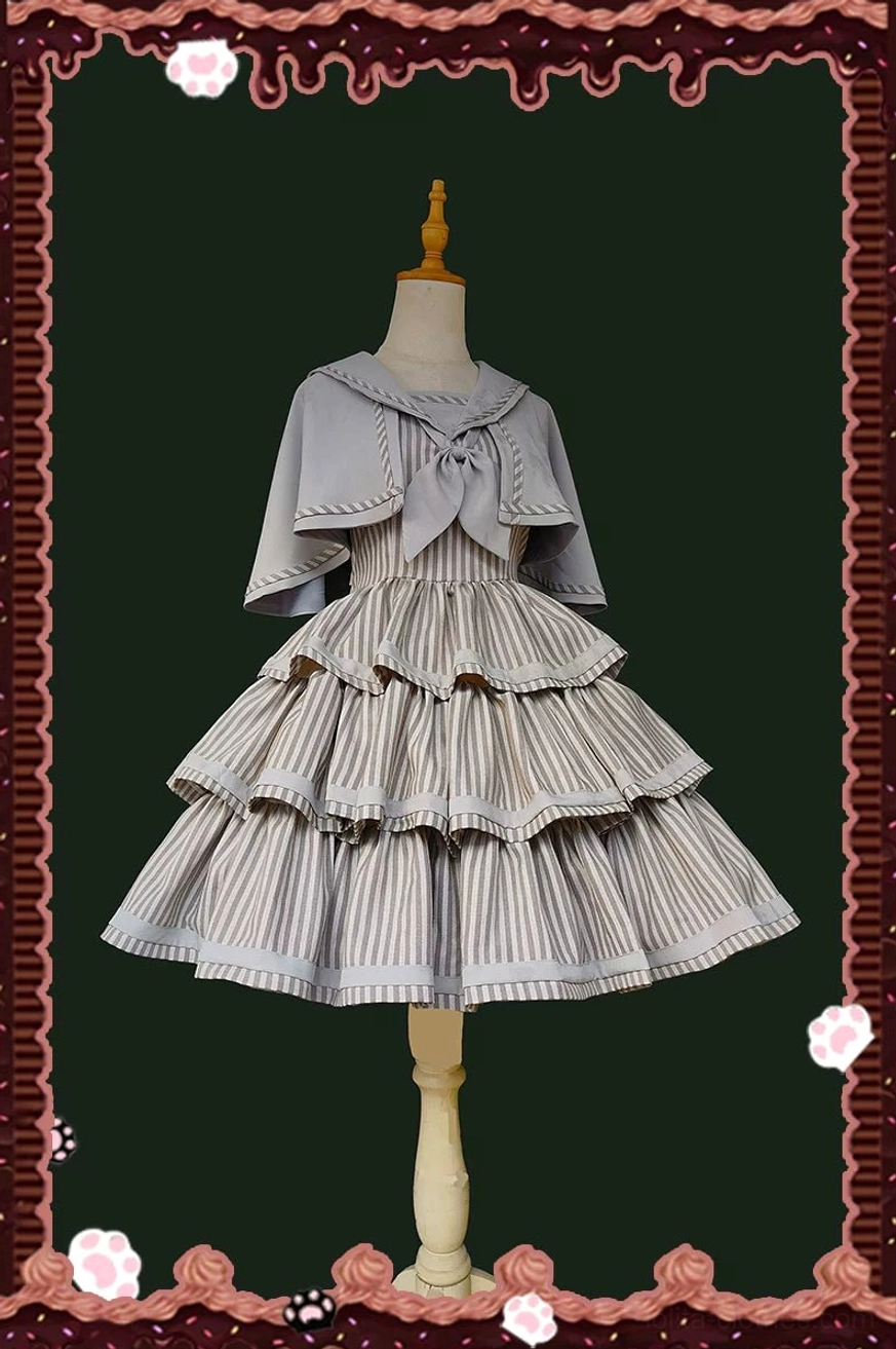Front display of grey and brown striped Lolita JSK with sailor collar and matching cape on dress form, featuring light grey sailor collar with bow detail and vertically striped layered ruffled cake skirt construction